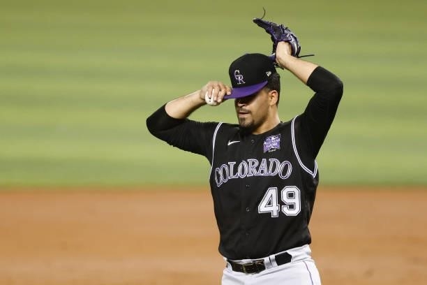 Antonio Senzatela of the Colorado Rockies reacts after allowing a two-run triple by Corey Dickerson of the Miami Marlins during the third inning at...