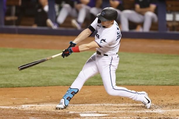 Corey Dickerson of the Miami Marlins hits a two-RBI triple against the Colorado Rockies during the third inning at loanDepot park on June 08, 2021 in...