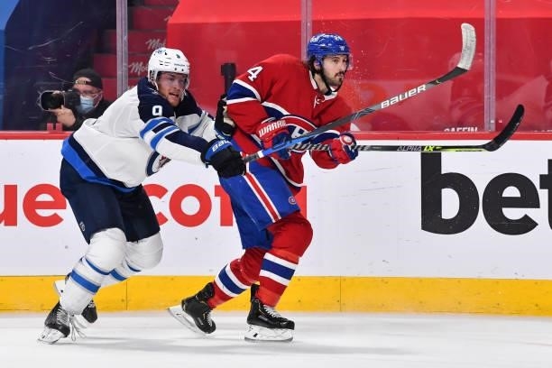 Andrew Copp of the Winnipeg Jets and Phillip Danault of the Montreal Canadiens skate against each other during the second period in Game Four of the...