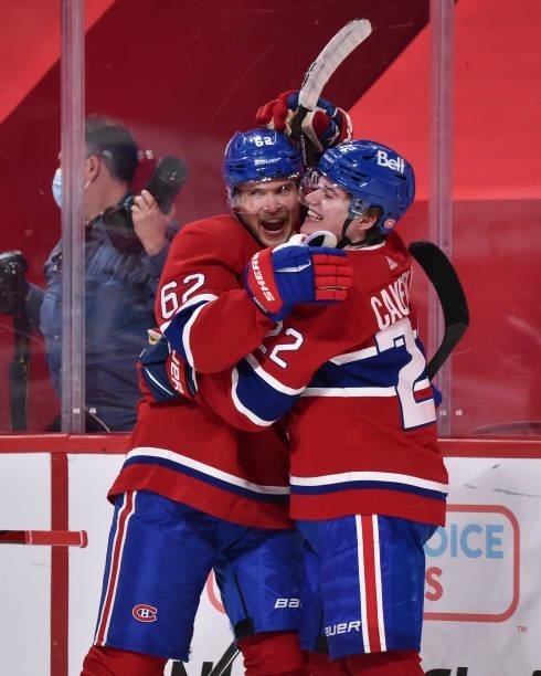 Artturi Lehkonen of the Montreal Canadiens and Cole Caufield celebrate their victory over the Winnipeg Jets during overtime in Game Four of the...