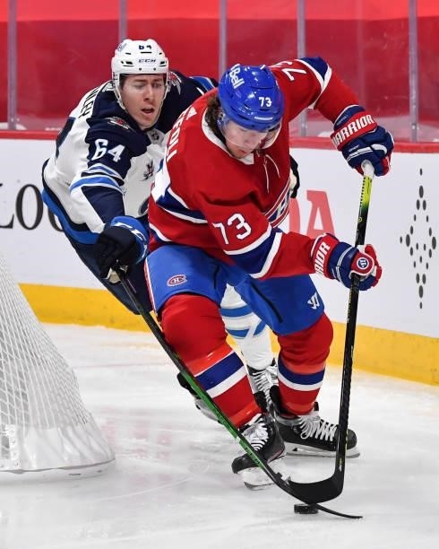 Logan Stanley of the Winnipeg Jets and Tyler Toffoli of the Montreal Canadiens skate for the puck during the second period in Game Four of the Second...