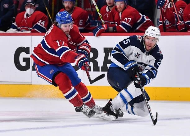 Josh Anderson of the Montreal Canadiens and Paul Stastny of the Winnipeg Jets skate against each other during the second period in Game Four of the...