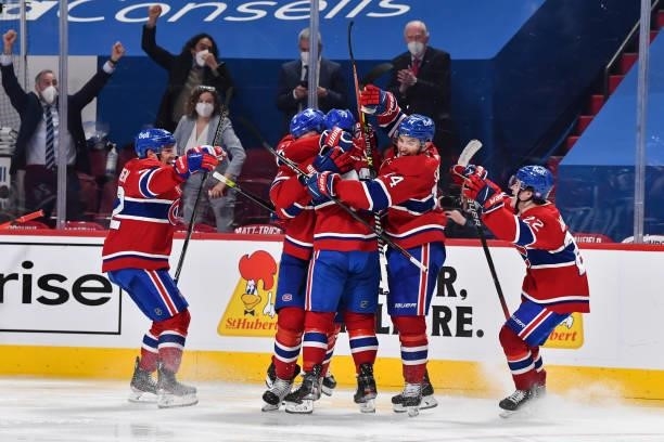 The Montreal Canadiens celebrate an overtime victory against the Winnipeg Jets in Game Four of the Second Round of the 2021 Stanley Cup Playoffs at...