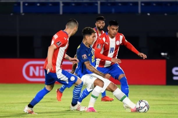 Roberto Firmino of Brazil competes for the ball with Santiago Arzamendia of Paraguay during a match between Paraguay and Brazil as part of South...