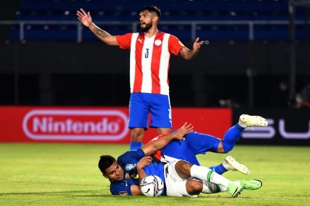 Omar Alderete of Paraguay reacts as teammate Miguel Almirón competes for the ball with Casemiro of Brazil during a match between Paraguay and Brazil...