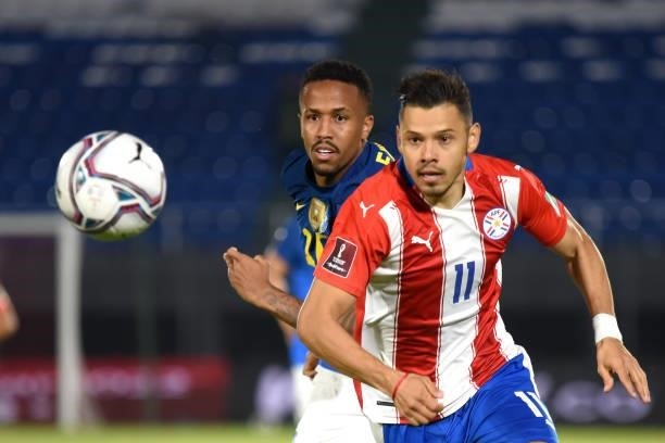 Ángel Romero of Paraguay competes for the ball with Eder Militão of Brazil during a match between Paraguay and Brazil as part of South American...