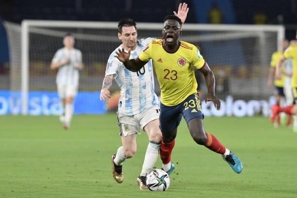 Lionel Messi of Argentina makes a foul to Davinson Sanchez of Colombia during a match between Colombia and Argentina as part of South American...
