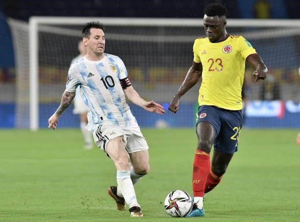 Lionel Messi of Argentina fights for the ball with Davinson Sanchez of Colombia during a match between Colombia and Argentina as part of South...