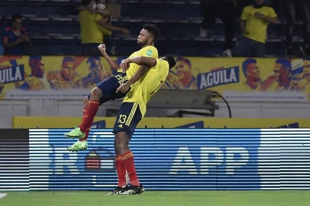 Miguel Borja of Colombia celebrates with Yerry Mina of Colombia after scoring the tying goal during a match between Colombia and Argentina as part of...