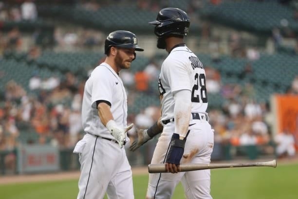 Niko Goodrum of the Detroit Tigers celebrates scoring a run in the second inning with Robbie Grossman while playing the Seattle Mariners at Comerica...