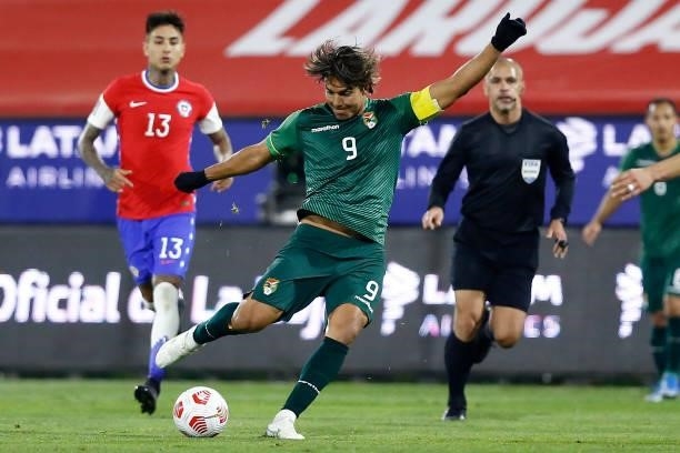 Marcelo Moreno Martins of Bolivia kicks the ball during a match between Chile and Bolivia as part of South American Qualifiers for Qatar 2022 at...