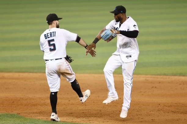 Jon Berti and Starling Marte of the Miami Marlins celebrate the final out after defeating the Colorado Rockies 6-2 at loanDepot park on June 08, 2021...
