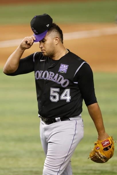 Carlos Estevez of the Colorado Rockies reacts as he is taken out of the game in the seventh inning after allowing two runs against the Miami Marlins...