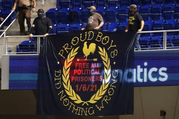 Fans display a banner reading "Proud Boys Did Nothing Wrong