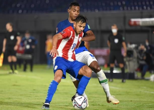 Ángel Romero of Paraguay competes for the ball with Alex Sandro of Brazil during a match between Paraguay and Brazil as part of South American...