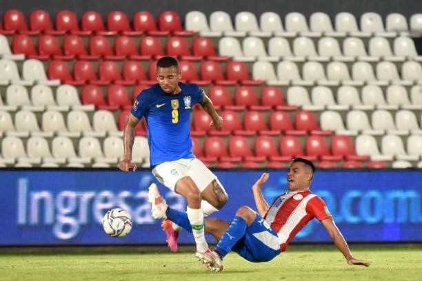 Gabriel Jesus of Brazil competes for the ball with Gastón Giménez of Paraguay during a match between Paraguay and Brazil as part of South American...