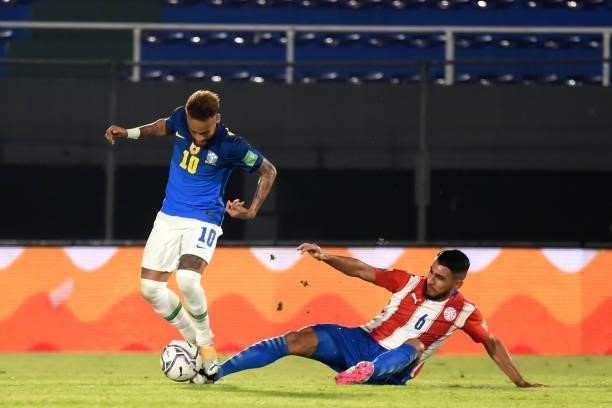 Neymar of Brazil competes for the ball with Junior Alonso of Paraguay during a match between Paraguay and Brazil as part of South American Qualifier...
