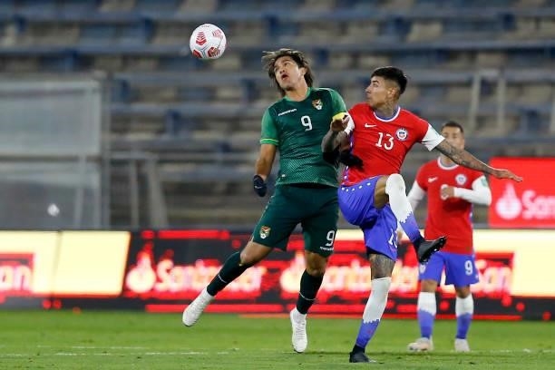 Marcelo Moreno Martins of Bolivia competes for the ball with Erick Pulgar of Chile during a match between Chile and Bolivia as part of South American...
