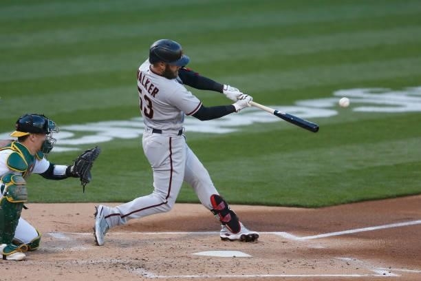 Christian Walker of the Arizona Diamondbacks hits a solo home run in the top of the second inning against the Oakland Athletics at RingCentral...