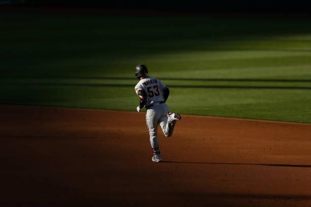 Christian Walker of the Arizona Diamondbacks rounds the bases after hitting a solo home run in the top of the second inning against the Oakland...