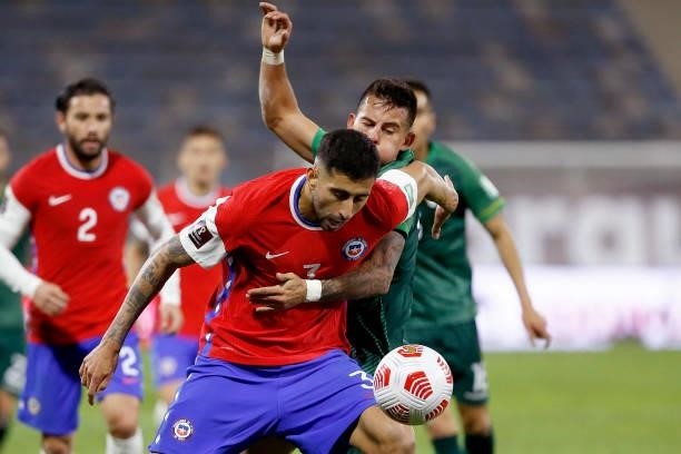 Guillermo Maripán of Chile competes for the ball with Henry Vaca of Bolivia during a match between Chile and Bolivia as part of South American...
