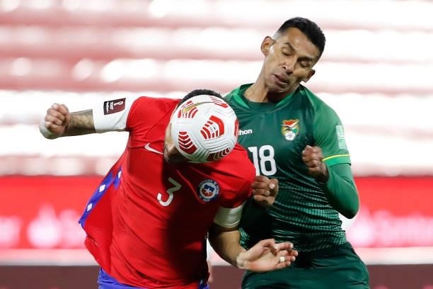 Guillermo Maripán of Chile competes for the ball with Gilbert Alvarez of Bolivia during a match between Chile and Bolivia as part of South American...