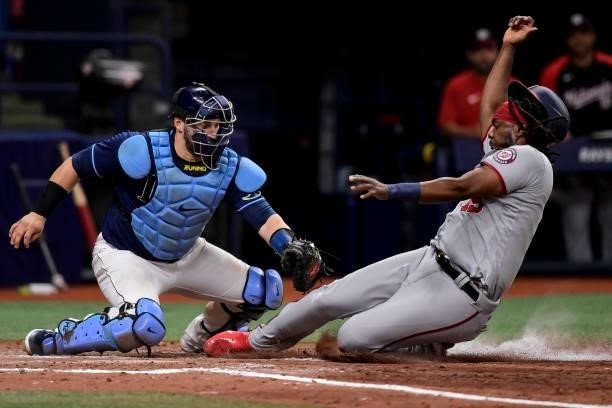 Josh Bell of the Washington Nationals is tagged out at home plate by Mike Zunino of the Tampa Bay Rays during the seventh inning at Tropicana Field...