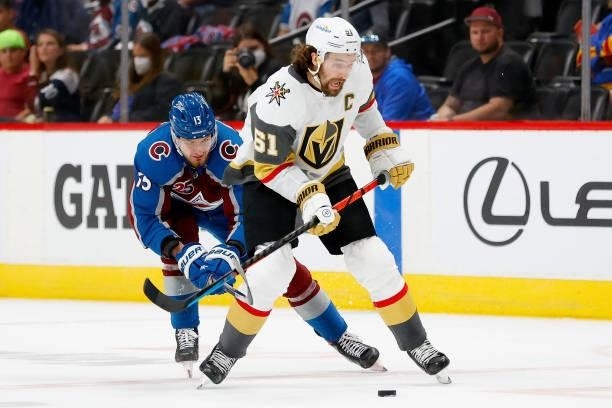 Mark Stone of the Vegas Golden Knights is caught from behind by Valeri Nichushkin of the Colorado Avalanche during the second period in Game Five of...