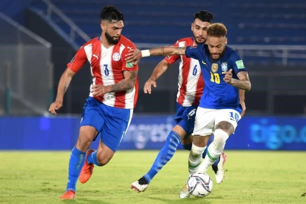 Neymar of Brazil competes for the ball with Omar Alderete and Junior Alonso of Paraguay during a match between Paraguay and Brazil as part of South...