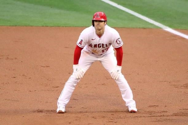 Shohei Ohtani of the Los Angeles Angels waits for the play on first base during the first inning against the Kansas City Royals at Angel Stadium of...
