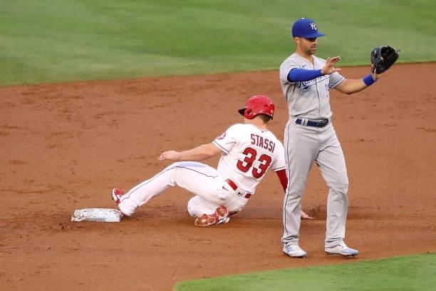 Max Stassi of the Los Angeles Angels slides into second base against Whit Merrifield of the Kansas City Royals during the first inning at Angel...