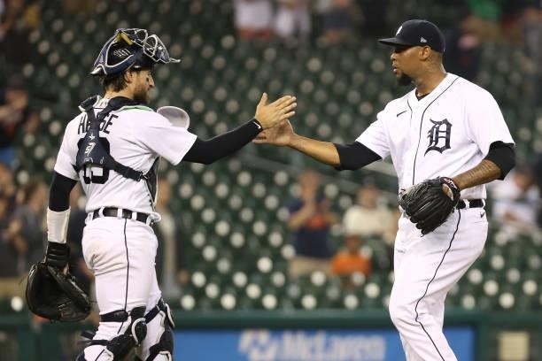 Jose Cisnero of the Detroit Tigers celebrates a 5-3 win over the Seattle Mariners with Eric Haase at Comerica Park on June 08, 2021 in Detroit,...