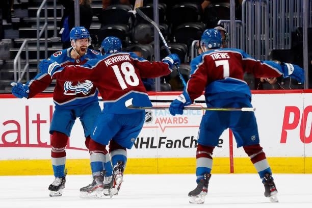 Joonas Donskoi of the Colorado Avalanche celebrates with Alex Newhook and Devon Toews after scoring against the Vegas Golden Knights during the...