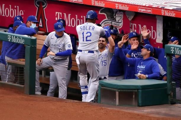 Jorge Soler of the Kansas City Royals celebrates his home run with Whit Merrifield in the dugout during the second inning against the Los Angeles...