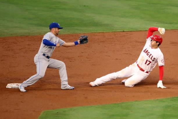 Shohei Ohtani of the Los Angeles Angels slides into second base against Whit Merrifield of the Kansas City Royals during the second inning at Angel...