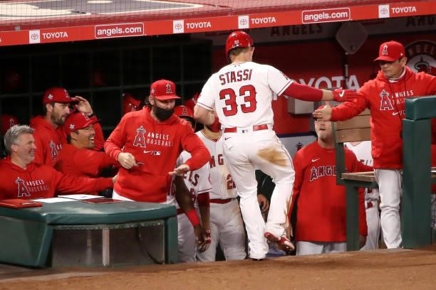 Max Stassi of the Los Angeles Angels celebrates his two run home run in the dugout during the fifth inning against the Kansas City Royals at Angel...