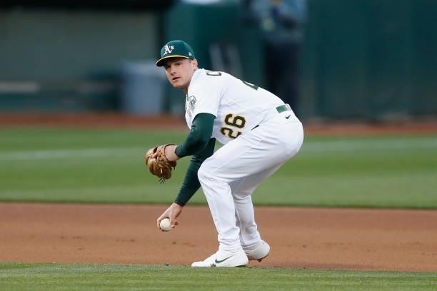 Matt Chapman of the Oakland Athletics fields the ball and throws to first base to get the out of David Peralta of the Arizona Diamondbacks at...