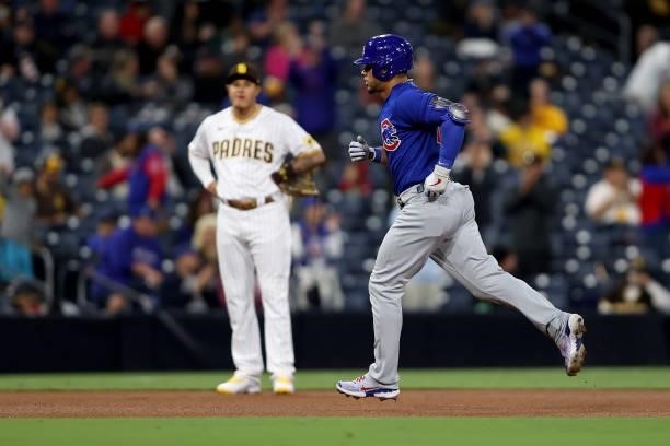 Manny Machado of the San Diego Padres looks on as Willson Contreras of the Chicago Cubs rounds the bases after hitting a solo homerun during the...