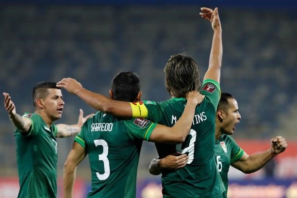 Marcelo Moreno Martins of Bolivia celebrates with teammates after scoring the first goal of his team during a match between Chile and Bolivia as part...