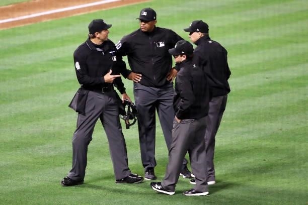 Umpire Chad Fairchild discusses a play during the game between the Los Angeles Angels and the Kansas City Royals at Angel Stadium of Anaheim on June...
