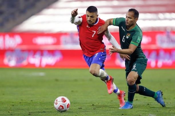 Alexis Sánchez of Chile competes for the ball with Leonel Justiniano of Bolivia during a match between Chile and Bolivia as part of South American...
