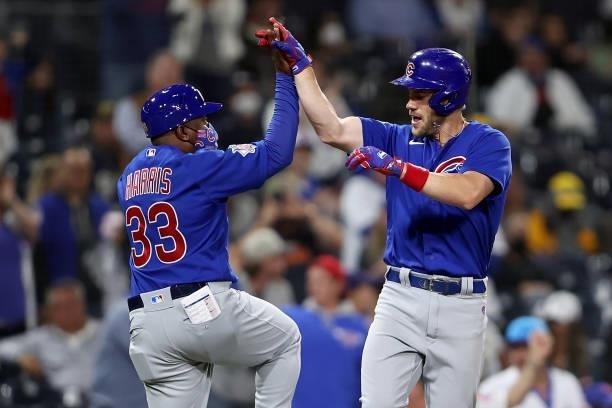 Third base coach Willie Harris congratulates Patrick Wisdom of the Chicago Cubs after his two-run homerun in the sixth inning of a game against the...
