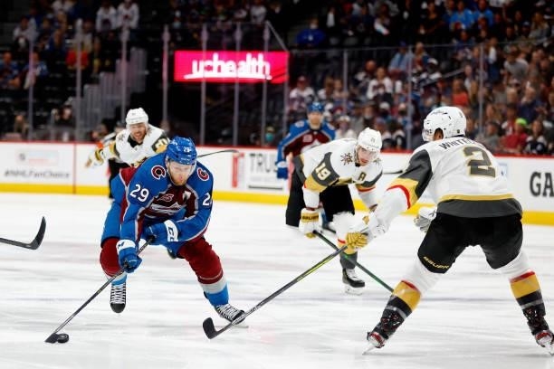 Nathan MacKinnon of the Colorado Avalanche advances the puck against Zach Whitecloud of the Vegas Golden Knights during the third period in Game Five...