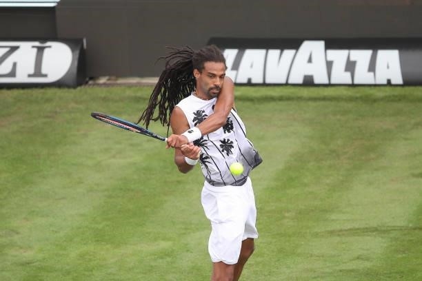 Dustin Brown of Germany plays a backhand in his match against Nikoloz Basilashvili of Georgia during day 2 of the MercedesCup at Tennisclub...
