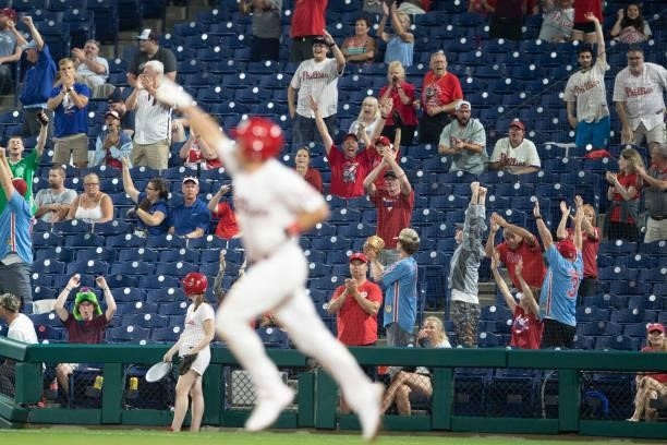 Fans react after a solo home run by J.T. Realmuto of the Philadelphia Phillies in the bottom of the sixth inning against the Atlanta Braves at...