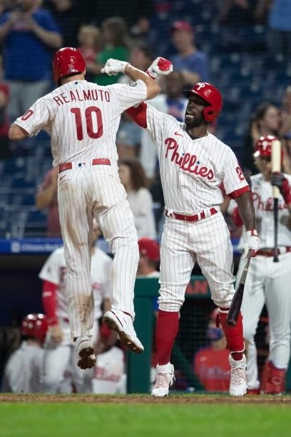 Realmuto of the Philadelphia Phillies celebrates with Andrew McCutchen after hitting a solo home run in the bottom of the sixth inning against the...