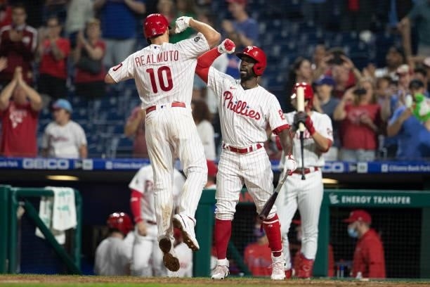 Realmuto of the Philadelphia Phillies celebrates with Andrew McCutchen after hitting a solo home run in the bottom of the sixth inning against the...
