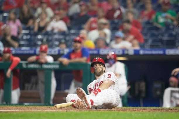 Bryce Harper of the Philadelphia Phillies looks on from the ground after avoiding being hit by a pitch in the bottom of the seventh inning against...