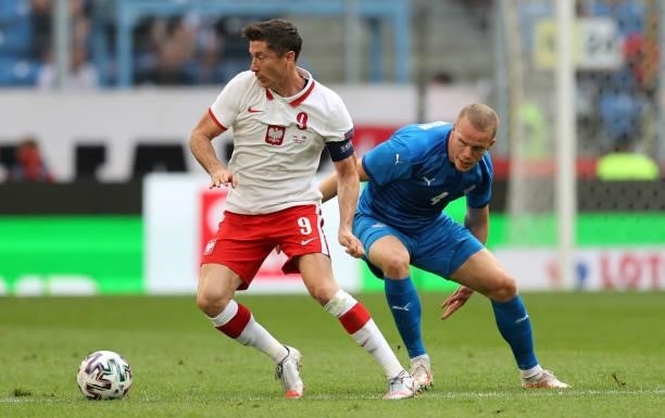 Robert Lewandowski of Poland is challenged by Hjortur Hermannsson of Iceland during the international friendly match between Poland and Iceland at...