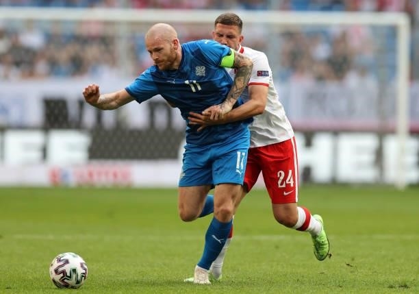 Albert Gudmundsson of Iceland is challenged by Jakub Swierczok of Poland during the international friendly match between Poland and Iceland at...